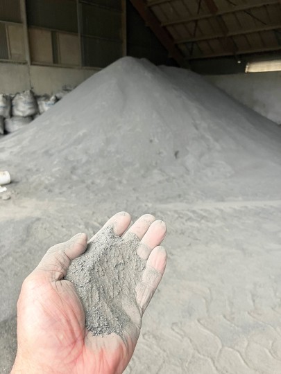 Ground, powdery basalt at a quarry in Dunedin, occurring here as a byproduct of producing aggregate for the construction industry. Basalt is a rock type targeted for application in ERW. (Photo: Gavin Hartley, Blackhead Quarries Ltd)